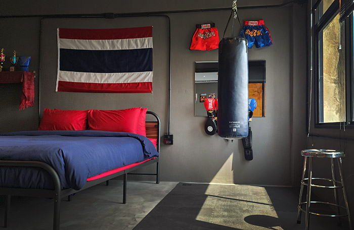 This cinematic set features an actual Muay Thai training gym built right into the room, complete with a heavy bag, gloves, wraps, pads, shin guards, and rubber gym flooring. There is equipment for two here, ready for you to sweat it out sparring or strike poses for your socials to capture this one-of-a-kind Bangkok experience.