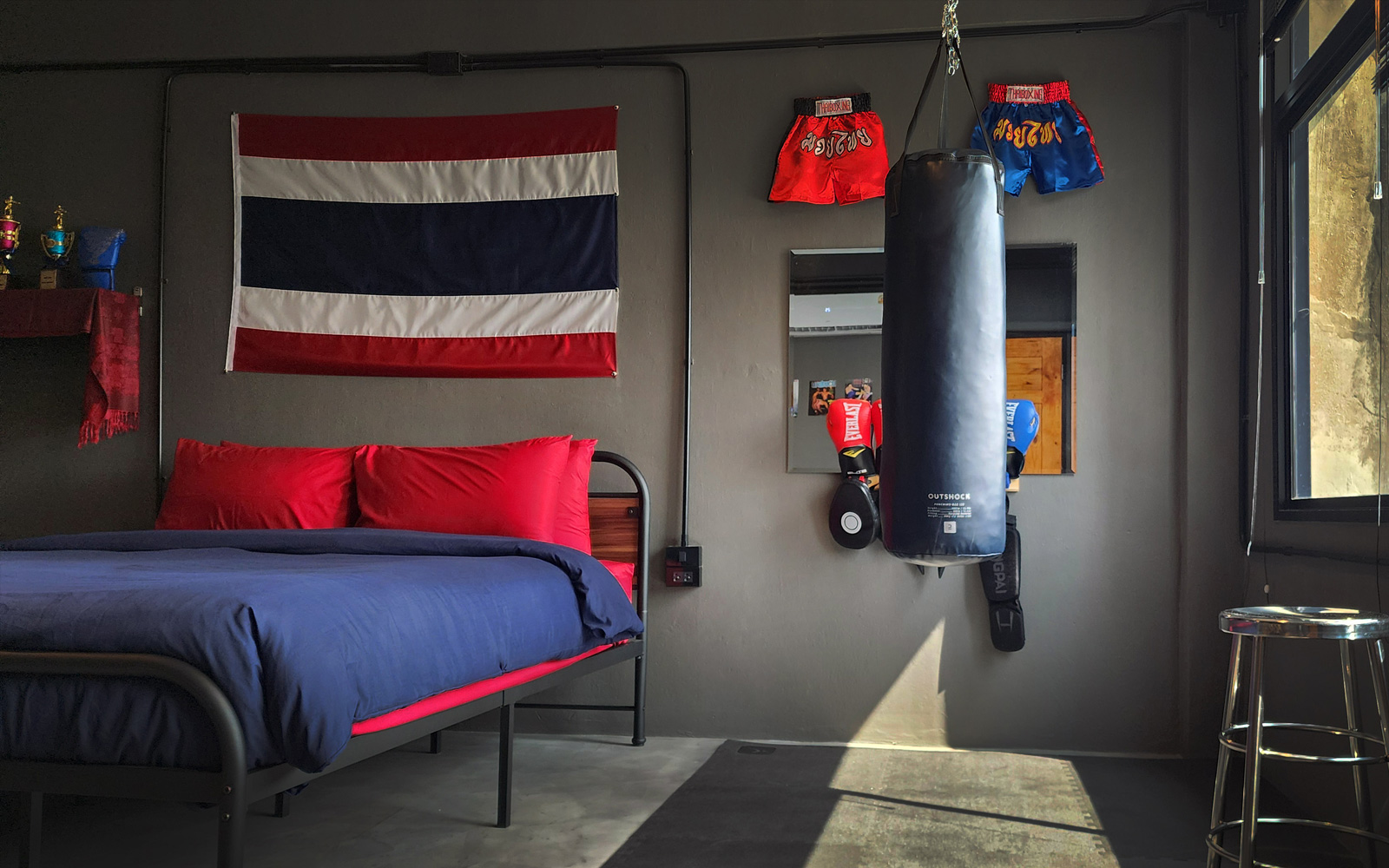 This cinematic set features an actual Muay Thai training gym built right into the room, complete with a heavy bag, gloves, wraps, pads, shin guards, and rubber gym flooring. There is equipment for two here, ready for you to sweat it out sparring or strike poses for your socials to capture this one-of-a-kind Bangkok experience.