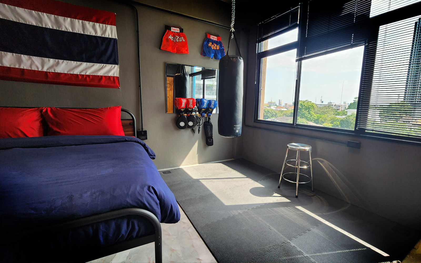 Part luxury room, part Muay Thai dojo, this cinematic set combines comfort and action with a full gym with usable equipment along with a supremely comfortable king bed, private bath, and streaming media/gaming server.